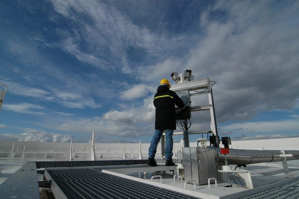 An HVAC consultant inspects some machinery.