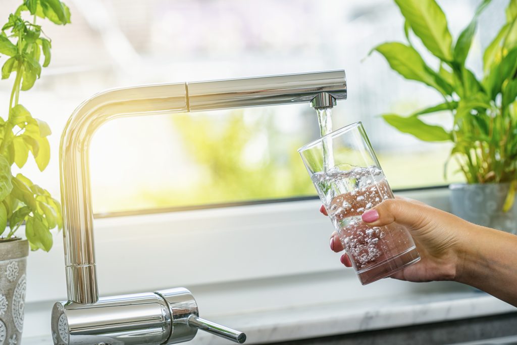 Clean water pouring from a tap with a water purification system.