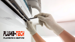 Hands in white gloves inspecting an HVAC system